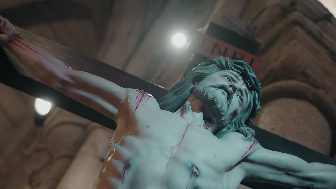 close up of jesus crucifix statue showing wounds and sorrowful expression