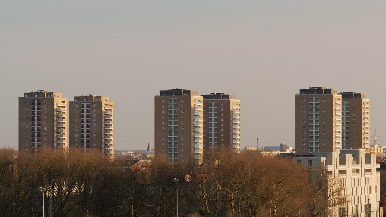 Wide-angle view of six identical social housing towers in Luchtbal, Antwerp, Belgium during sunset
