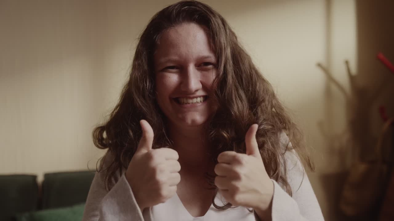 Happy woman giving thumbs up gesture