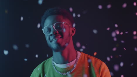 happy man in neon lights with confetti