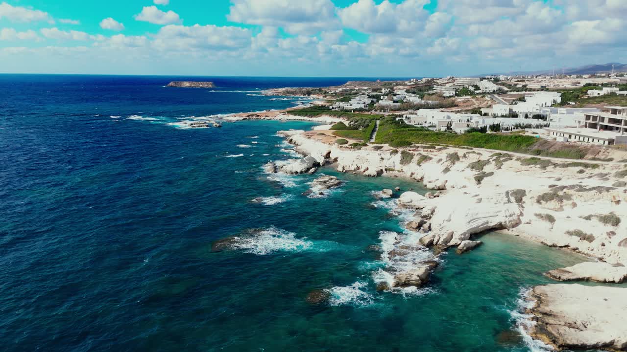 Experience the breathtaking beauty of Malta's coastline with its clear blue waters, rugged rocks, and lush surroundings on a bright sunny day at the beach