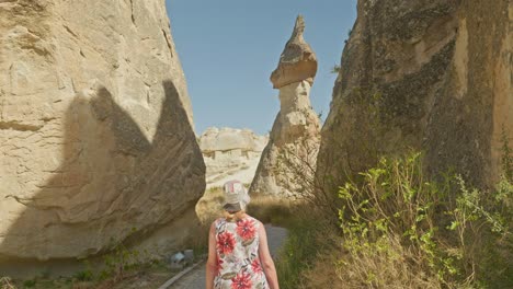 mujer turista explora el paisaje rocoso de la chimenea de las hadas de capadocia