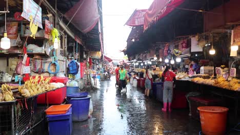 vendors and shoppers in a wet market alley