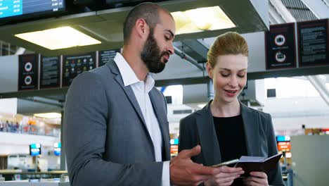 business people discussing over smartphone