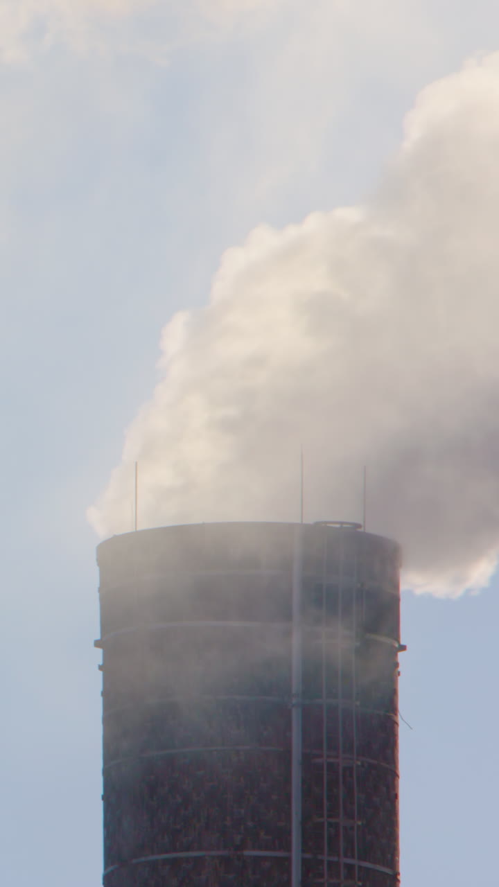 Plumes of factory smoke carbon emissions released into atmosphere, vertical