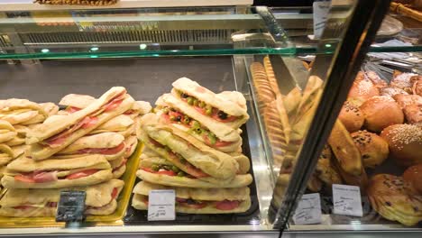 assorted sandwiches and pastries in a paris bakery