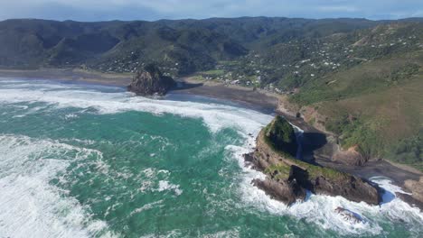 piha beach with lion rock and caramel rock in waitakere ranges regional park, auckland region, north island, new zealand