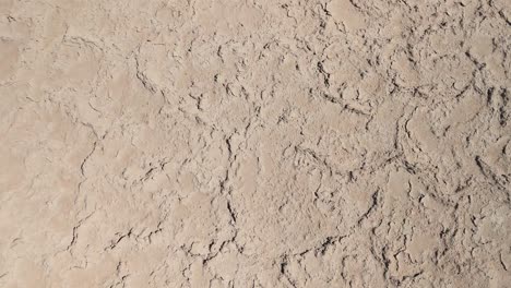 drone footage of the atacama desert showcasing salt crusts, saline soil, and lithium deposits. the aerial view highlights the arid landscape with irregular patterns formed by the salty surface.