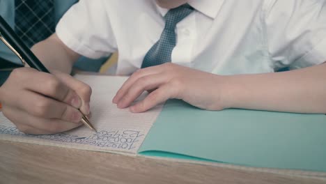 schoolchildren do homework write numbers in notebook