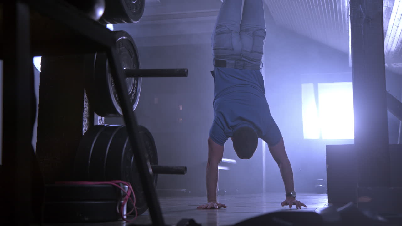 Man doing handstand in gym