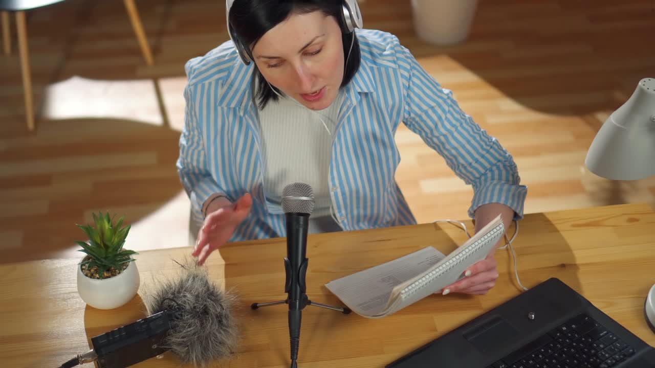 woman records a podcast while sitting at a table in her living room,top view