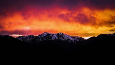 colorful sunset time lapse of snow capped mountains in estes park, colorado.