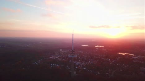 drone shot of kiel transmission tv tower with a reddish evening sky