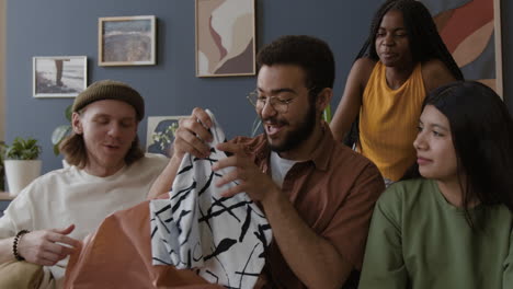 friends unwrapping a surprise gift