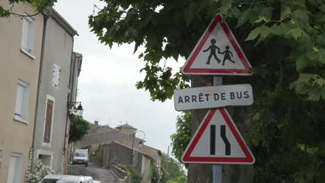 a french bus stop sign in a small town in the south of france