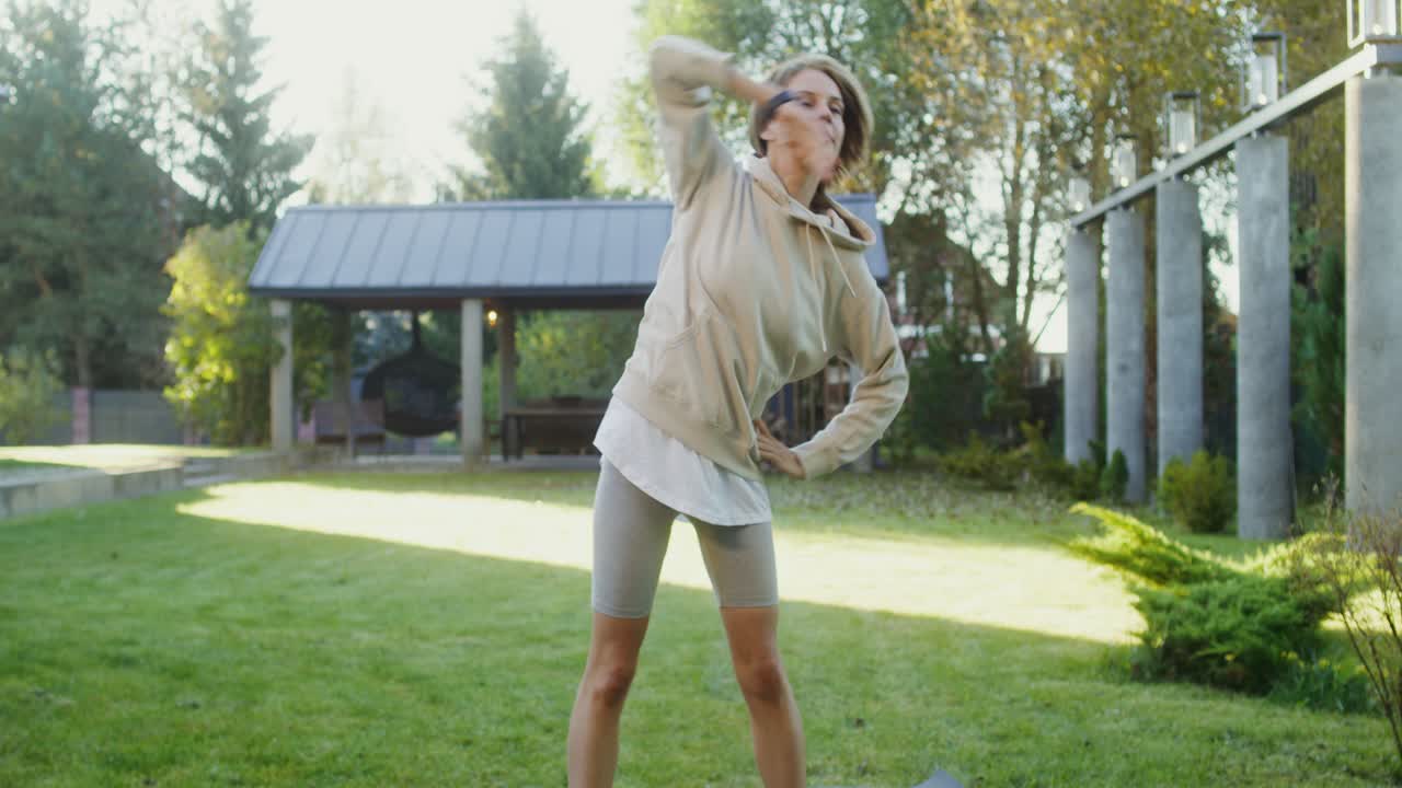 mujer estirándose en el jardín del patio trasero