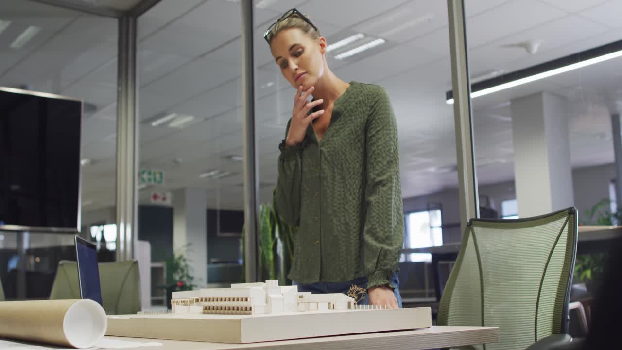 Video of focused caucasian female designer working on project