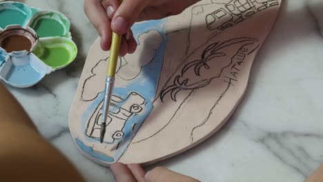 children painting pottery