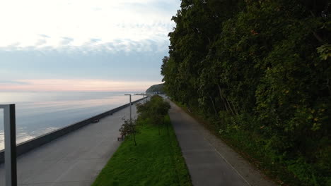 drone fly over esplanade with lush trees in seaside boulevard of gdynia, poland