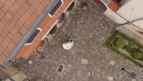 encantadores recién casados novia caucásica novio bailando en la calle de la ciudad, pareja de bodas familia, vista aérea