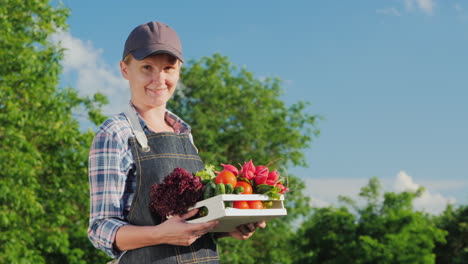 Ortrait-Of-A-Female-Farmer-With-A-Box-Of-Fresh-Vegetables-From-Her-Garden