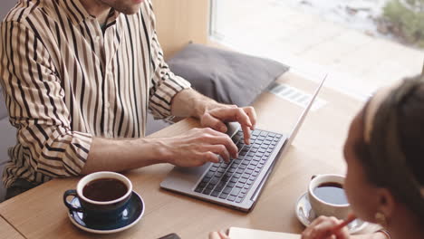 two business colleagues having meeting in cafe