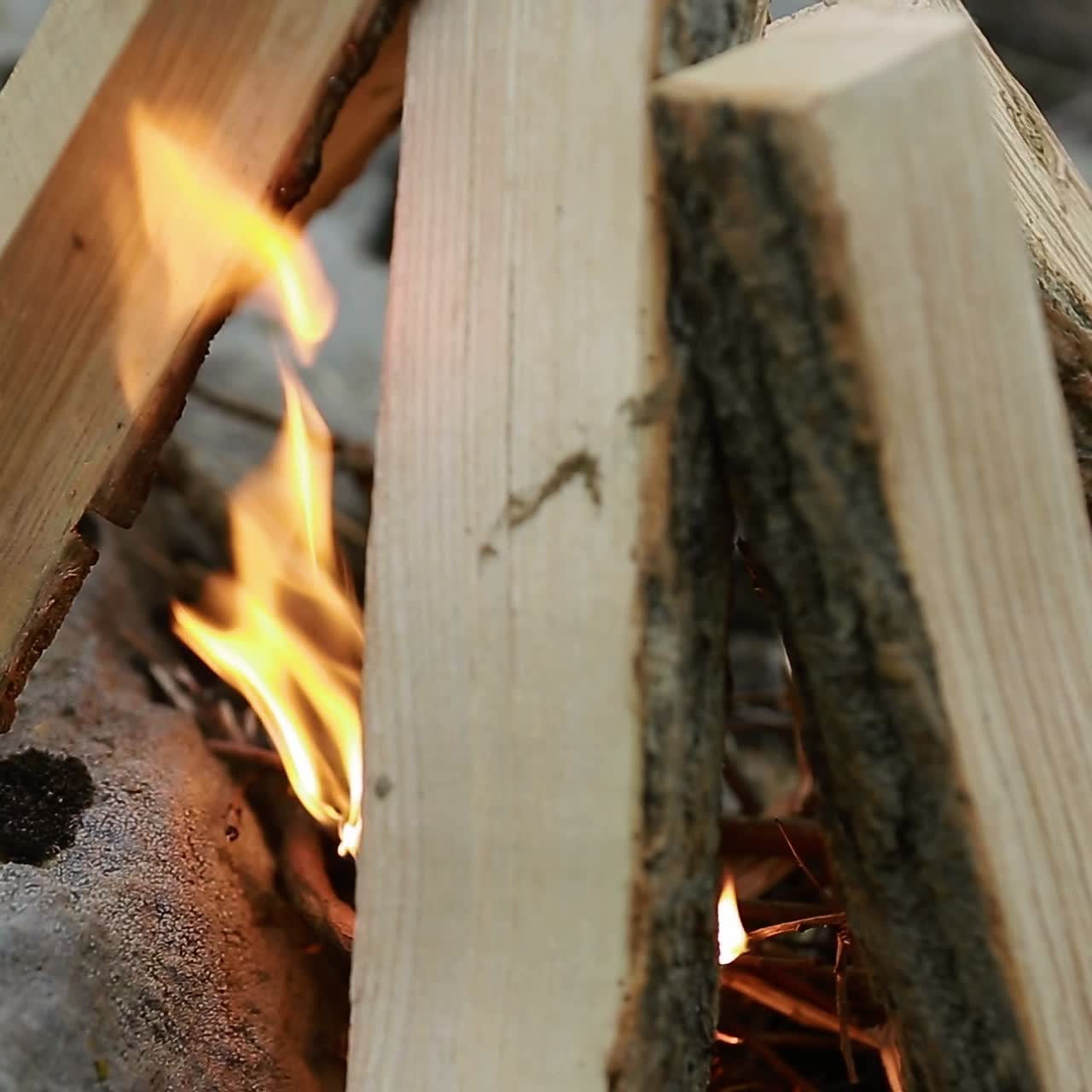Making Camp Fire In Nature. Young man who making a camp fire in nature