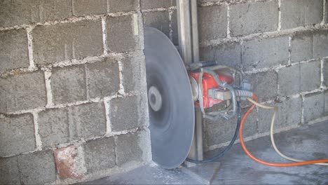 water cutting concrete bricks with big circular saw and stopping after finished