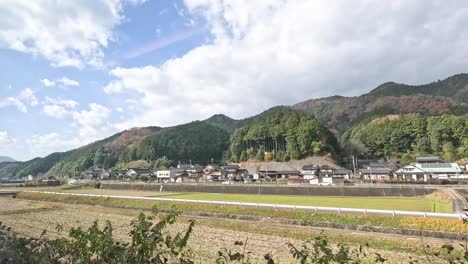 time-lapse of a tranquil rural village and fields.