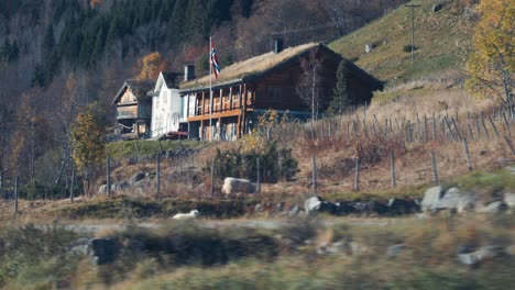 a traditional sod roof houses stand at the bottom of the mountain