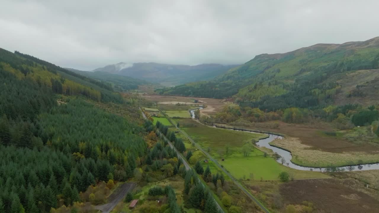 Road through Scottish Highland valley, high aerial shot