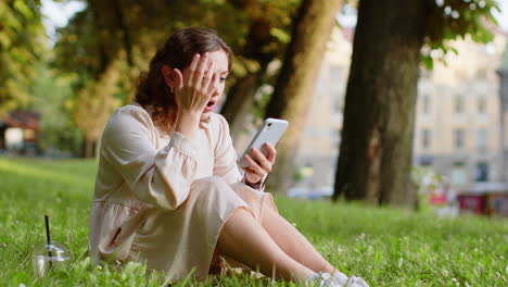 Surprised-young-woman-use-smartphone-loses,-bad-news,-fortune-loss,-fail-outdoors-in-city-park