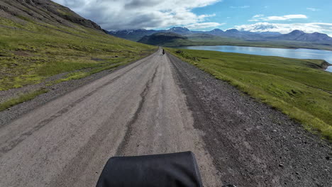 first-person perspective of cycling along a rugged gravel path through the remote dalabyggð region of iceland, capturing the immersive experience of bike travel through untamed wilderness