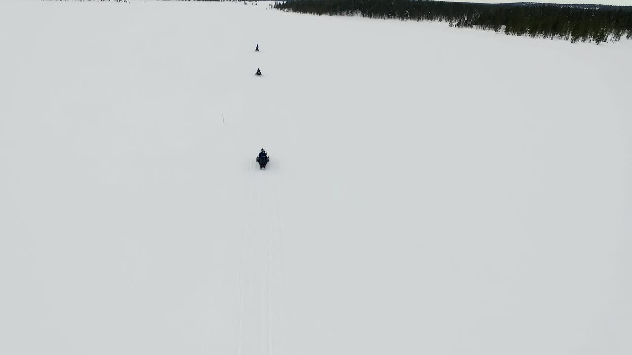 Snowmobiling in a Snowy Landscape