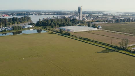 aerial fly over farming cranberries marijuana canabis thc cement in richmond bc canada right by the fraser river where boats are dry docked for repair and transport cargo for import export services