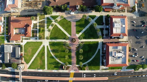aerial view of a symmetrical campus plaza with palm trees and fountain