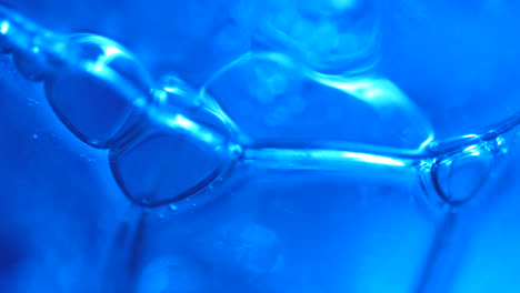 blue bubbles in abstract macro background slow motion