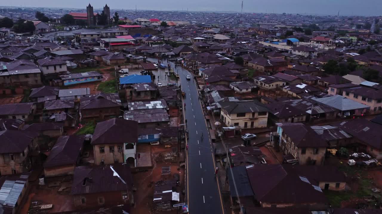 Stunning aerial of a calm road running through the neighborhood of a large city in Nigeria, Africa