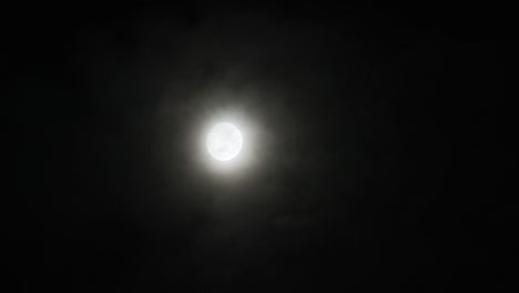 a realtime shot of the moon and clouds at night