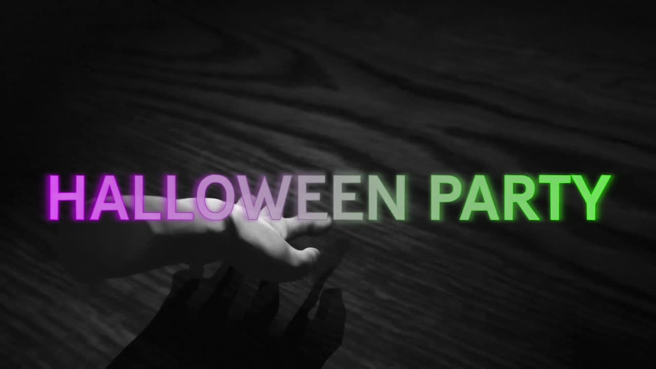 Hand reaching out over wooden surface with HALLOWEEN PARTY animation in colorful text