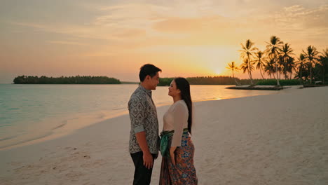 couple on a tropical beach at sunset