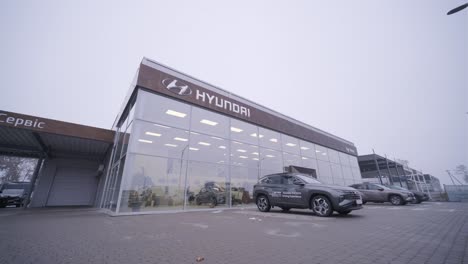 car dealership with row of anonymous new vehicle on sale. showroom with shiny auto. automotive