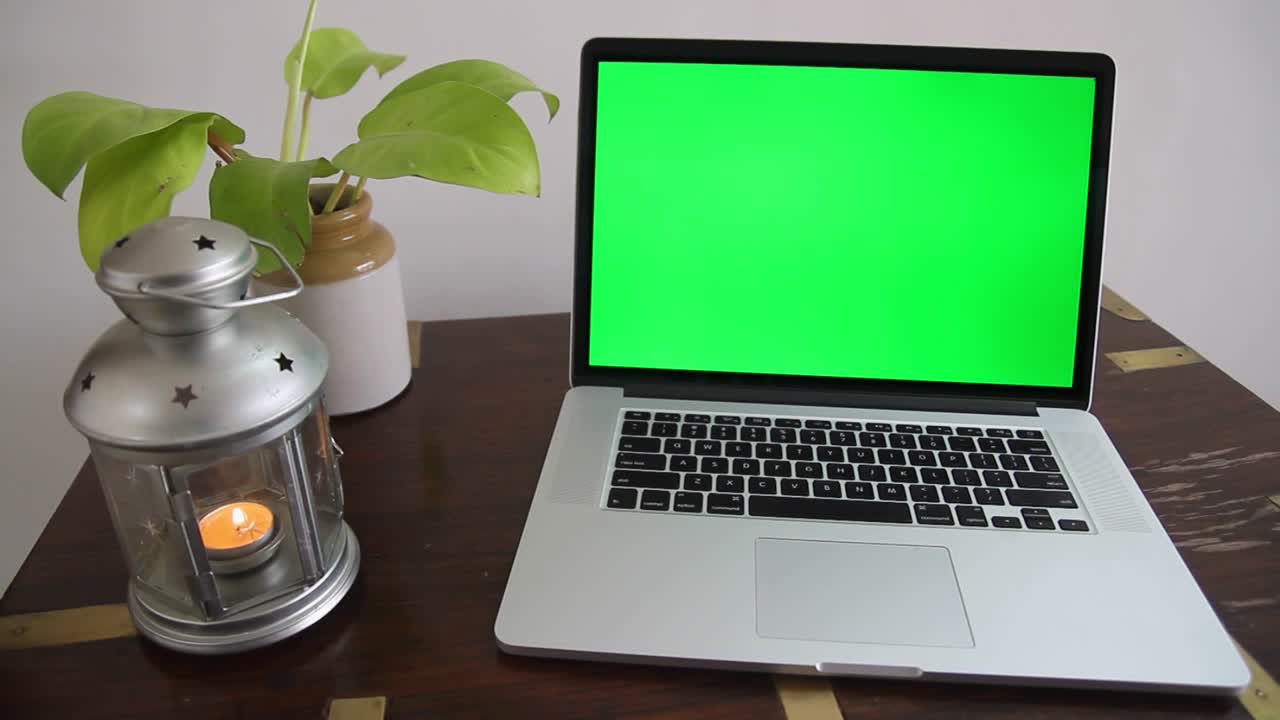 A laptop with a green screen which can be removed to place any content as per the requirement