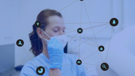 network of social media icons animation over healthcare worker adjusting face mask