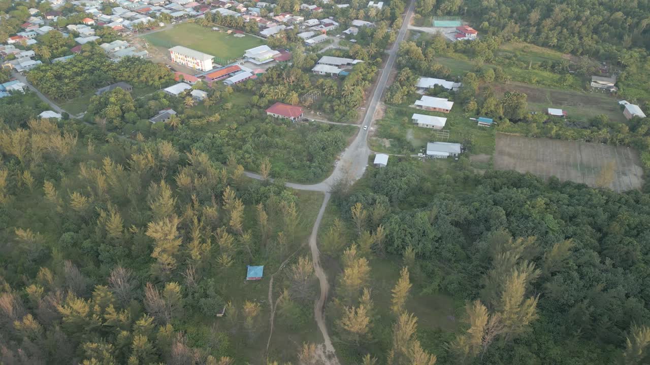 Aerial Drone View During Summer Gerigat Fishing Village,Kabong With, Facing Open Blue Sea, White Sandy Beach,Green Coconut, Palm Trees,And River,Sarawak,Borneo