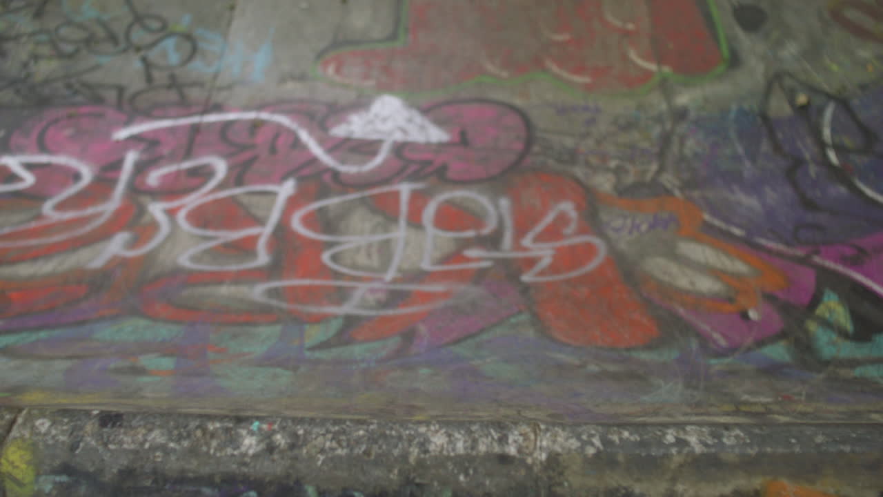 Boy's feet riding on skateboard in the park.