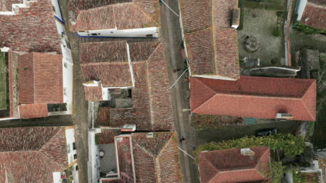 aerial top view of tiled roof houses in the medieval town of óbidos portugal - aerial drone shot