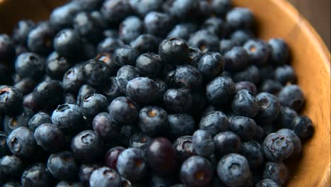 close up of fresh blueberry in wooden plate