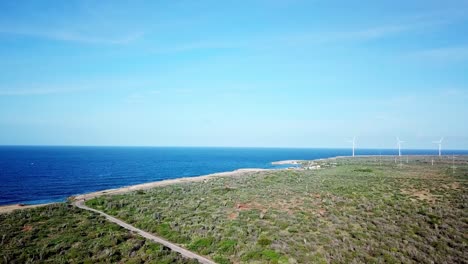 Dolly-in-aerial-view-of-Kanoa-Beach,-frequented-by-surfers-on-the-Dutch-island-of-Curacao,-Caribbean-Sea