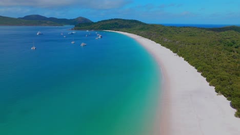 barcos del extremo sur de la costa de vacaciones de la playa de whitehaven isla de whitsundays parque nacional de sunny port airlie australia aus qld gran barrera exterior de arrecife azul claro océano turquesa hacia adelante movimiento de panorámica